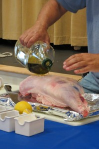 Adding olive oil to the leg of lamb