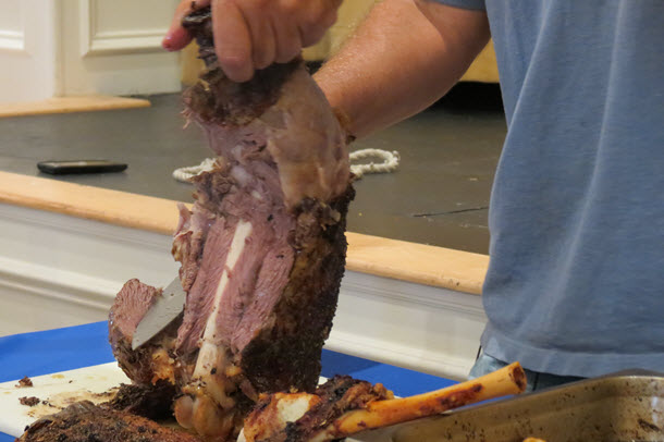 Slicing down the bone - leg of lamb