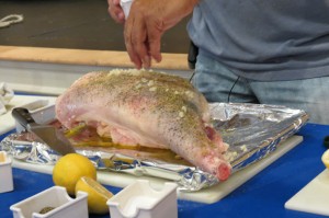 adding the minced garlic to the leg of lamb