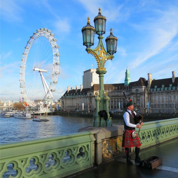 Baby Boomer Travel | London, England | Bagpiper - London Eye