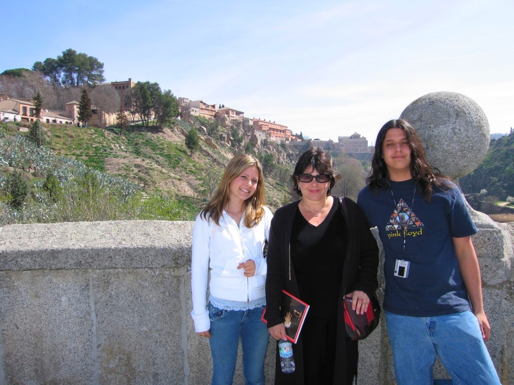 Standing on the St Martins Bridge in Toledo Spain with my kids #travelspain #toledospain #stmartinsbridge