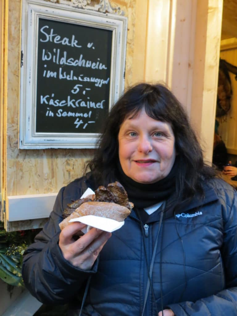 The food at German Christmas markets is always divine. Eating a Eating a steak w Wildschwein sandwich at the Thurn und Taxis Christmas Market in Regensburg, Germany #ChristmasMarkets #holidays #Regensburg #Germany