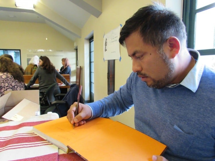 Ricardo Zarate signing his book