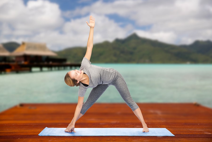 Triangle pose - It’s great for a full body stretch - #womenover50 #fitnessover50 #yogaposes #easyyoga