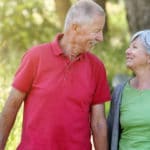 Older couple walking woods