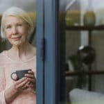 Woman at window of home