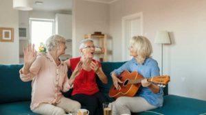Senior women playing guitar and singing