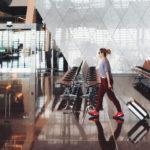 How to handle emergencies while traveling - woman in an airport with suitcase