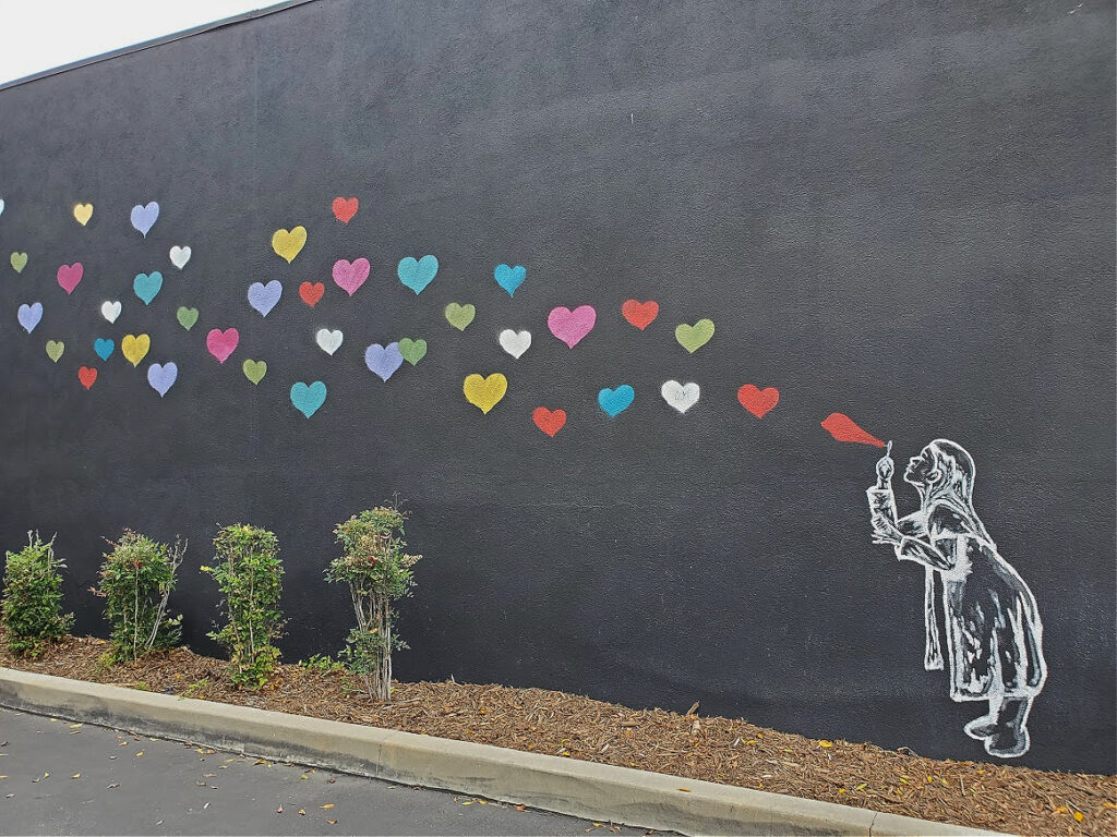 Girl blowing hearts in Magnolia Park