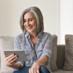 Older woman online reading a blog