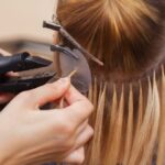 Woman getting hair extensions.